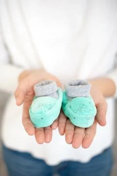 Booties on the palms Stock Photos