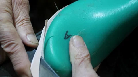 Bootmaker drive in nails in a shoe at the private workshop. Shoe making proce Stock Footage 279748973