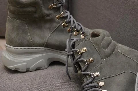 Boots with laces on a gray background.  Stock Photos