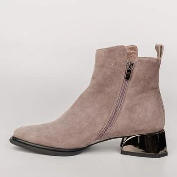 Boots made of soft material have a low square heel and side zipper for easy w Stock Photos