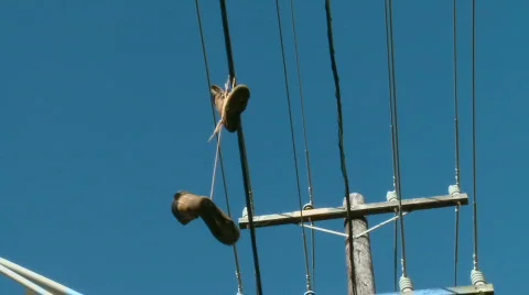 Boots on powerlines Stock Footage