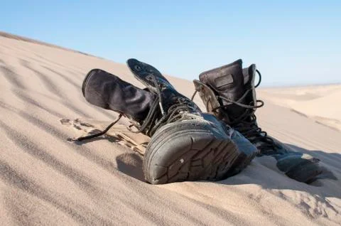 Boots in sand Stock Photos