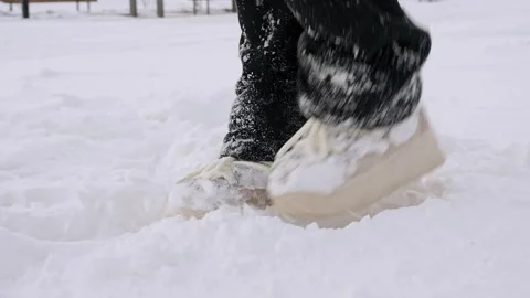 Boots in the snow on a snowy cold winter day Stock Footage 329234380
