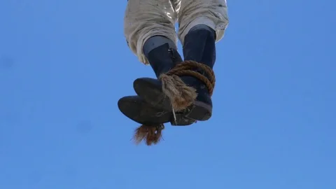 Boots sway in the wind after a hanging. Stock Footage 118046401
