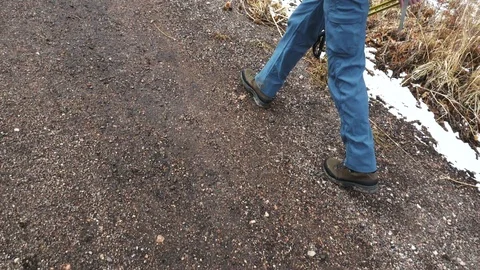 Boots Walking Down Rugged Red Dirt Road in Colorado Stock Footage 105233656