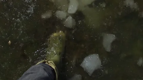 Boots walking through slush and ice pov slow motion Stock Footage 61374937