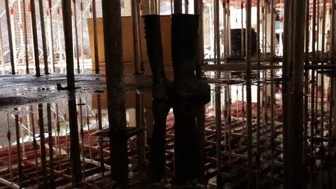 Boots on wet construction site Stock Footage 77100525
