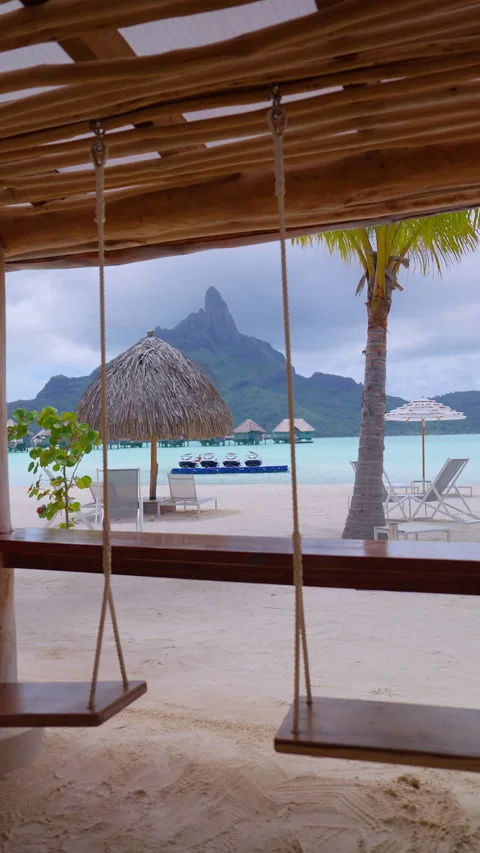 Bora Bora Beach Bar View with Wooden Swings and Mount Otemanu in Background. Stock Footage 342888643