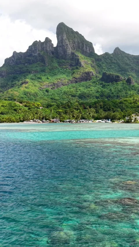 Bora Bora, French Polynesia. Vertical Drone Shot, Flying Above Coral Reefs and Stock Footage 346614194