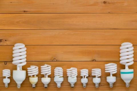 Border of assorted sized spiral light bulbs Stock Photos