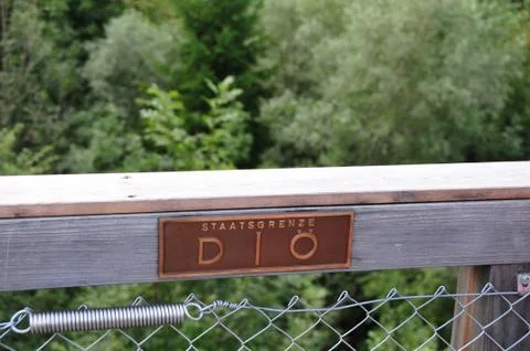 Border between Germany and Austria on a wooden railing Stock Photos