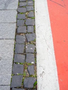Border between running track and street paving stones. Treadmill concept. S.. Stock Photos