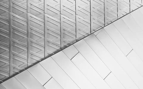 A border between two geometric patterns in a white facade. Stockfoto's