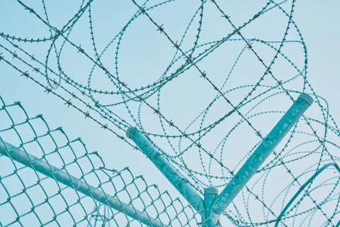 Border fence with barbed wire Stock Photos