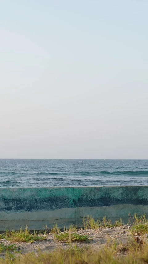 Border fence between Atlantic Ocean and beach. Stock Footage 276342376