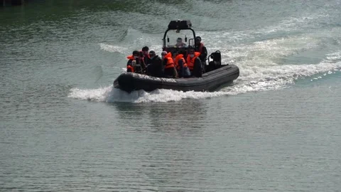 Border force officer bring migrant into Dover port, Kent, UK. 05/08/20 Stock Footage 137549751