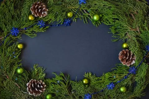 Border, frame from christmas tree branches with pine cones and blue berries Stock Photos