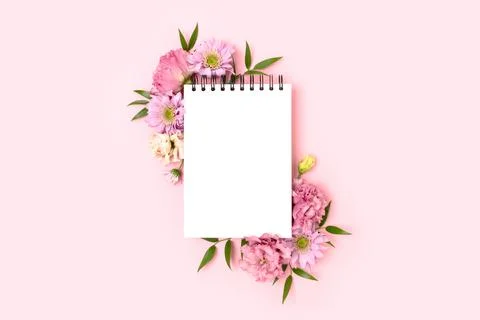 Border frame made of eustoma flower and empty notepad mockup Stock Photos