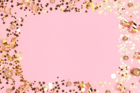 Border frame made of gold colored confetti. Stock Photos