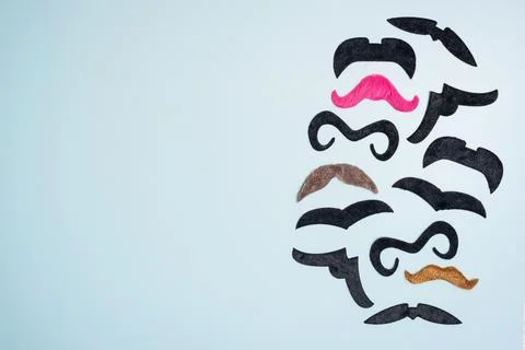 Border, frame make of different fake mustaches on blue background, copy space Stock Photos