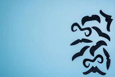 Border, frame make of different fake mustaches on blue background, copy space Stock Photos