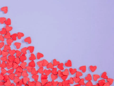 Border frame of red hearth-shape sprinkle on lilac purple background Stock Illustration