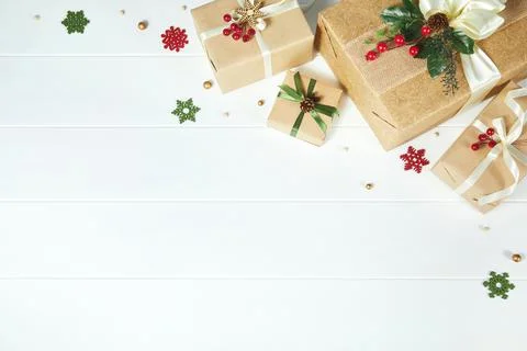 Border of gift boxes wrapped in kraft paper on white wood desk background Stock Photos