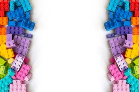 Border of A lot of Colorful Plastick constructor bricks on white background.  Stock Photos