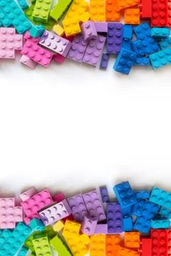 Border of A lot of Colorful Plastick constructor bricks on white background.  Stock Photos