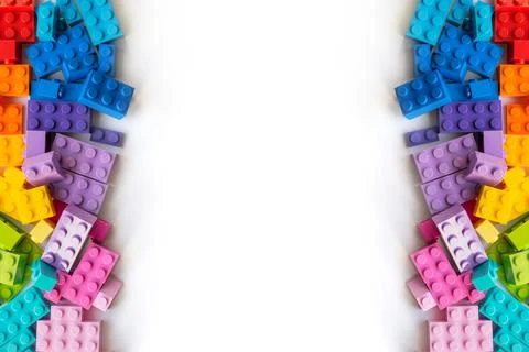 Border of A lot of Colorful Plastick constructor bricks on white background Stock Photos