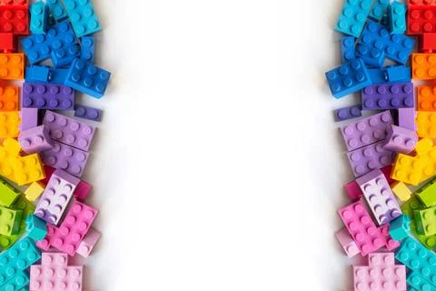 Border of A lot of Colorful Plastick constructor bricks on white backgroun... Stock Photos