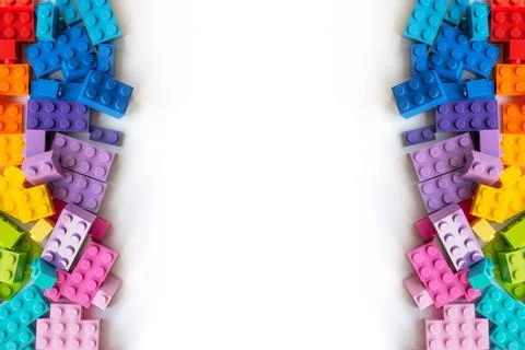 Border of A lot of Colorful Plastick constructor bricks on white backgroun... Stock Photos