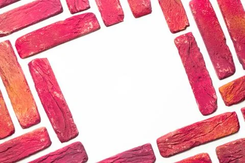 Border or frame made of multi colored bricks on white background. Top view, c Stock Photos