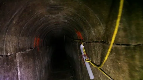 Border patrol agents use a remote controlled robot to explore a drug smuggling Stock Footage 123373595