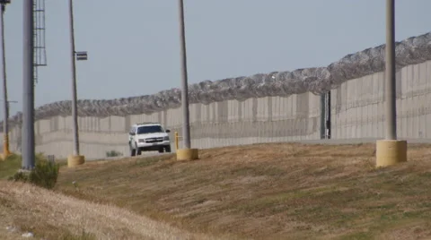A Border Patrol car sits between fences no man's land north of Tijuana, Mexico Stock-Footage 48605775