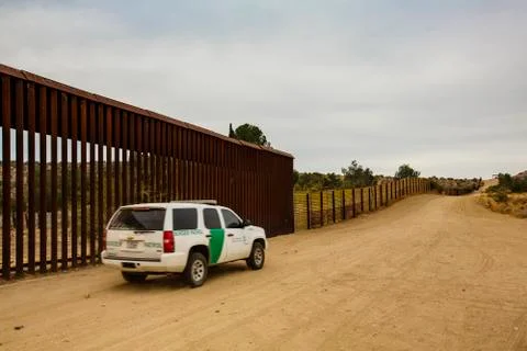 Border Patrol Driving Near Wall Stock Photos