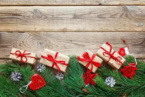 Border from the pine branches, Christmas decorations and gift boxes on an old Stock Photos