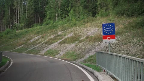 Border sign at Austrian-German state border entrance to Vorarlberg. Grenzzeichen Stock Footage 256326856