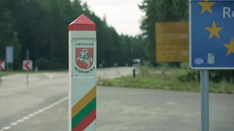 Border sign of the Republic of Lithuania with Coat of Arms, bus driveby Stock Footage 247369312