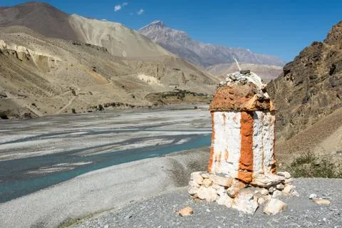 Border stone at the river bank Stock Photos