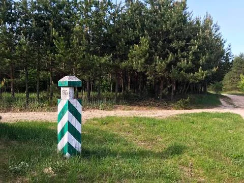 A border striped column in the forest. Stock Photos