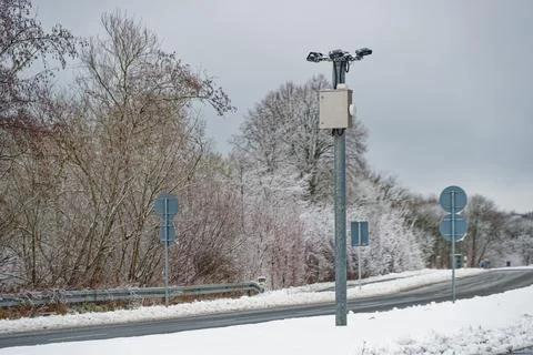 Border surveillance camera pole in snowy winter landscape Stock Photos
