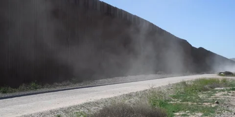 Border wall with dust of passing patrol vehicle, 4k Vídeo Stock 240969158