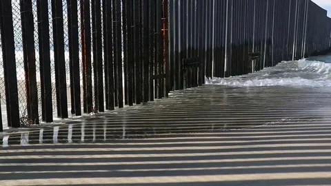 A Border Wall Meets the Ocean* Stock Footage 115129510