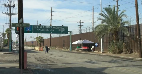 Border Wall at Mexican Border Between USA and Mexico Street Signs Country Line 動画素材 101030259