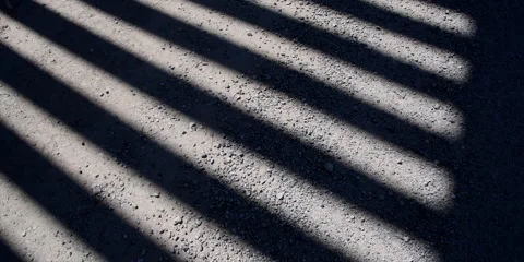 The Border Wall with shadow, camera tilts to show wall and road, 4k Stock Footage 240972170