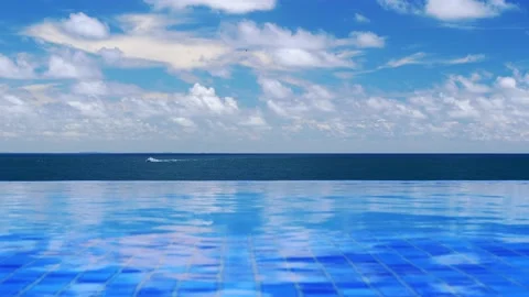 Borderless pool and ocean with blue water, sailboat at Morro de Sao Paulo Stock Footage 149678886