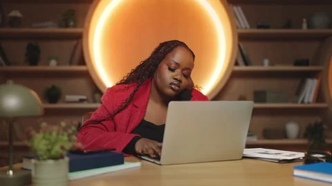 Bored African female manager working on laptop in office, low energy and fatigue Stock Footage 340764564