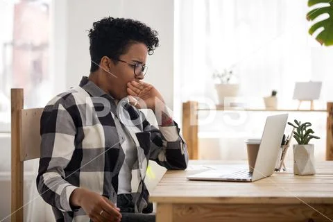 Bored black woman sitting at the desk Stock Photos