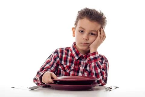 Bored boy at table Stock Photos